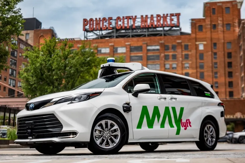 White May Mobility self-driving van with Lyft logo with Ponce Public Market sign in background in Atlanta, Georgia.